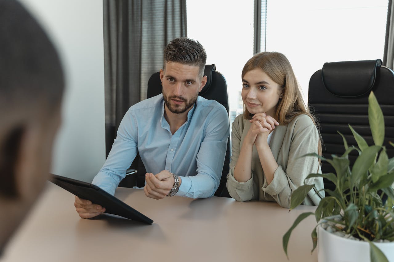 Mastering the First Impression: Your intriguing post title goes here A professional business meeting with diverse team discussing strategies in an office setting.