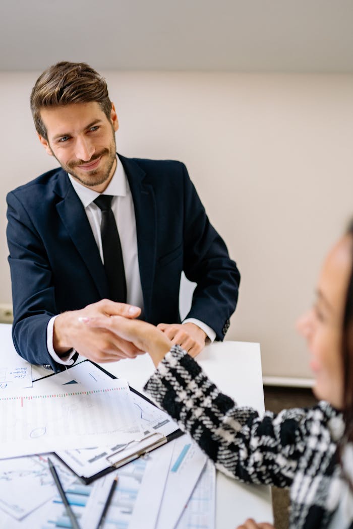 Crafting Captivating Headlines: Your awesome post title goes here Professional businessmen shaking hands in an office environment, focused on teamwork and agreement.